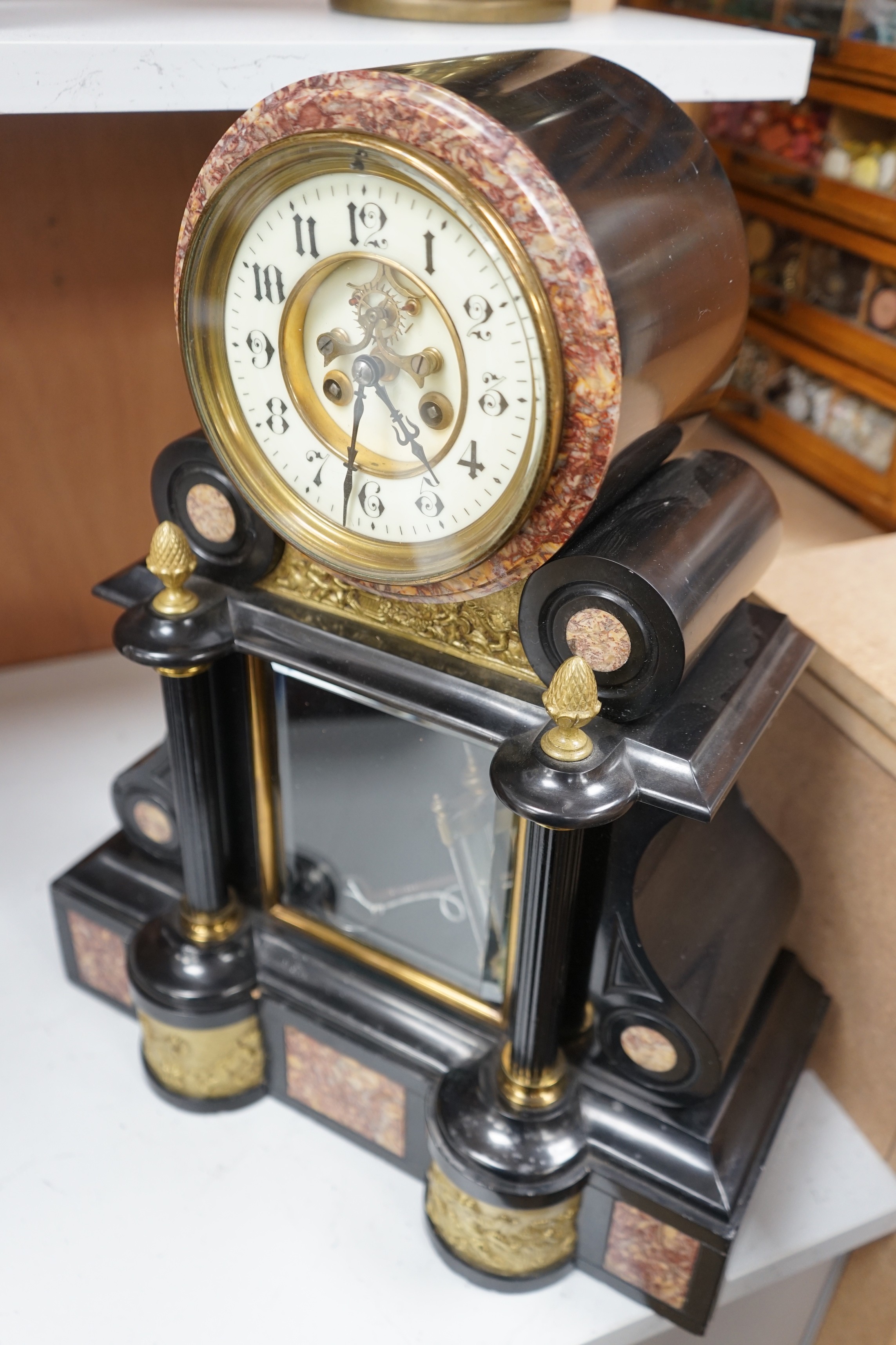 A large Edwardian decorative slate and marble clock, with visible Brocot escapement, height 48cms